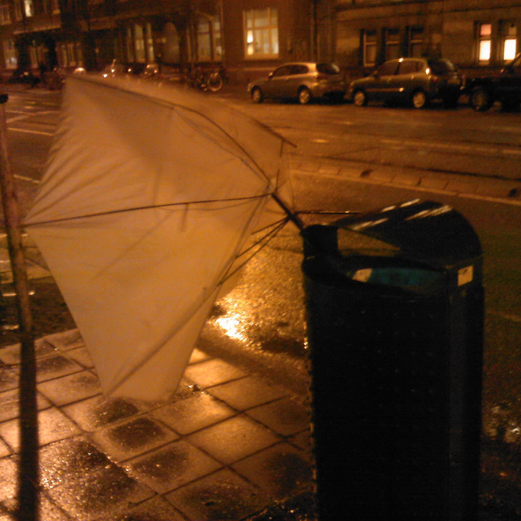 Nightly photo of a binned brolly, almost fly out because of wind